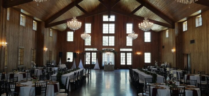 Elegant wedding reception hall with wooden beams and crystal chandeliers, one example of a venue style