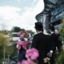 Racegoers in smart suits and a pink hat in the audience at Royal Ascot